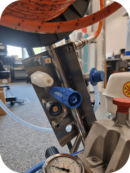 Professional using a portable drain cleaning machine inside a commercial or industrial building.